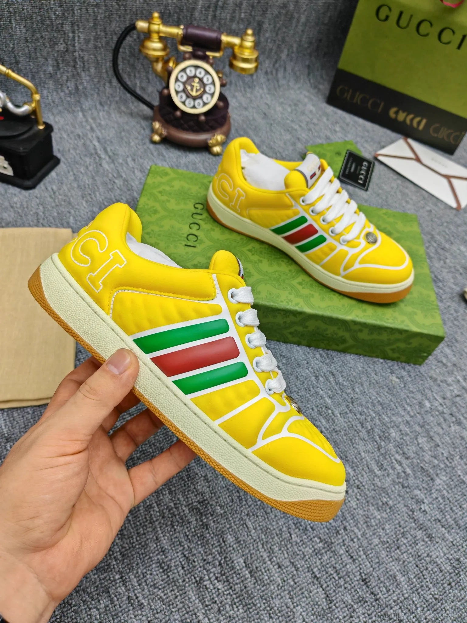 Factory price 600💰Screener series embellished web sneakers. This item is from the Gucci Lido series. Its design is inspired by the summer style and beach clubs of the Italian coast. The Screener series of sneakers draws inspiration from classic sneakers from the 1970s and takes its name from a special defensive move in sports. This shoe from the 2024 Pre-Fall collection is crafted from yellow rubber, a technical and malleable opaque material, with striped webbing on the sides and an embossed Gucci printed logo on the heel. Yellow rubber, opaque and technological in appearance. Red and green webbing decorated with metal Double G oval enamel details. Gucci printed embossed logo. Women 35-40, men 38-45, (men 38 and 45 need to be customized)
